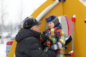 24985827 - the grandfather with his grandson playing at winter playground